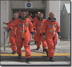 STS-117 crew walks out
